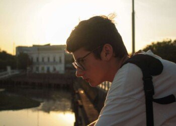 a man on the embankment in front of sunset