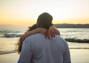 Couple posing together by the ocean in Nosara