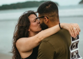 Couple posing together by the ocean in Nosara