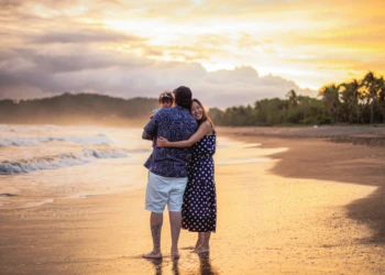 Family standing together by the ocean in Costa Rica