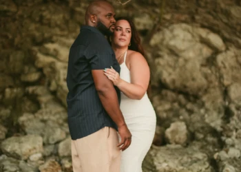 Couple posing together by the ocean in Nosara