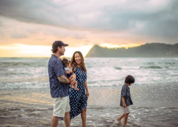 Family walking barefoot along the shoreline in Samara