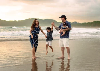Family standing together by the ocean in Costa Rica